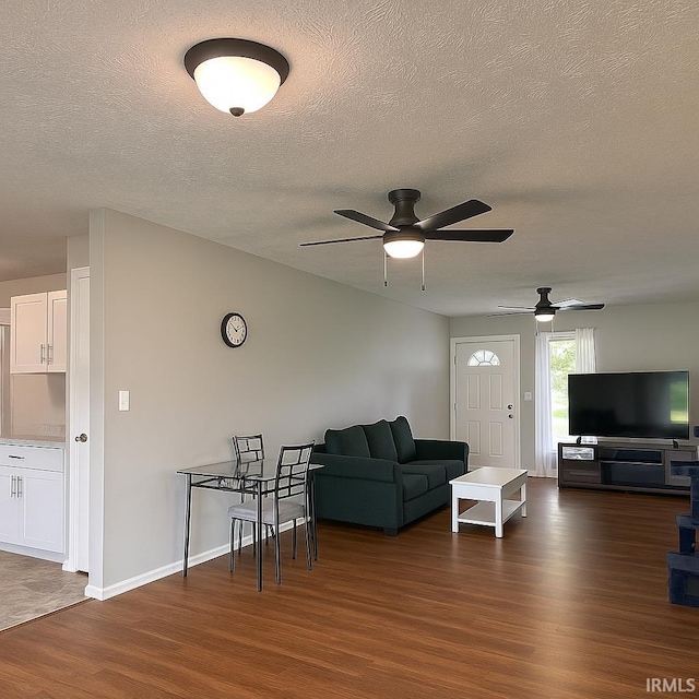 2014 N Macy Ln, Greensburg, IN 47240 - living area featuring dark wood-style flooring, a textured ceiling, ceiling fan, and baseboards
