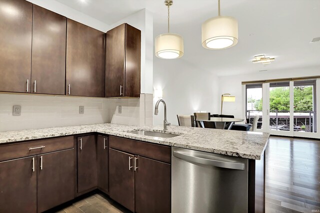 304 W Kirkwood Ave Unit 203, Bloomington, IN 47404 - kitchen with stainless steel dishwasher, a sink, a peninsula, tasteful backsplash, and dark wood-style flooring
