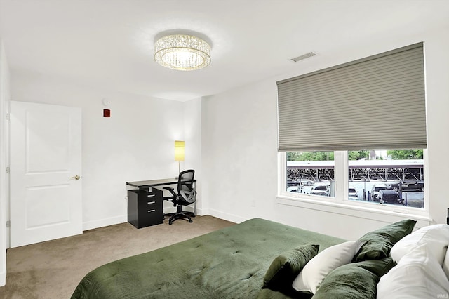 304 W Kirkwood Ave Unit 203, Bloomington, IN 47404 - bedroom with carpet floors, an office area, a chandelier, and baseboards