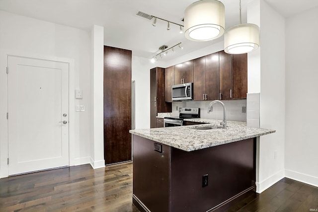 304 W Kirkwood Ave Unit 203, Bloomington, IN 47404 - kitchen with stainless steel appliances, a sink, dark wood-style floors, and baseboards