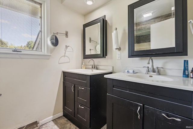 16828 Barryknoll Way, Granger, IN 46530 - bathroom featuring two vanities and baseboards