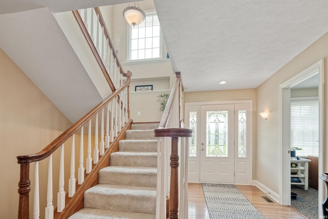 2006 Capital Hill Ct, Kokomo, IN 46902 - foyer entrance with light wood-style flooring, stairway, baseboards, a textured ceiling, and recessed lighting