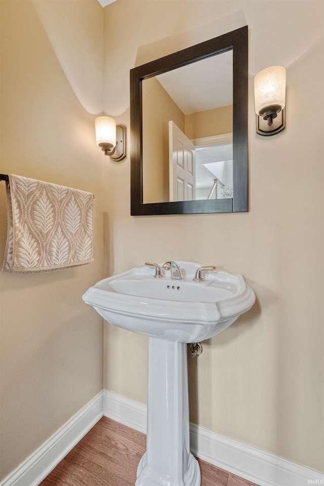 2006 Capital Hill Ct, Kokomo, IN 46902 - bathroom featuring baseboards, wood finished floors, and a sink