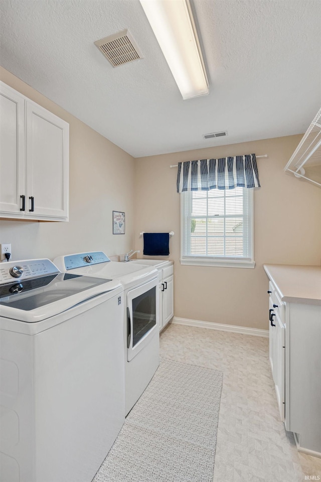 2006 Capital Hill Ct, Kokomo, IN 46902 - washroom featuring cabinet space, independent washer and dryer, baseboards, a textured ceiling, and light floors