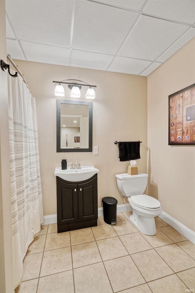 2006 Capital Hill Ct, Kokomo, IN 46902 - full bathroom featuring toilet, tile patterned floors, vanity, a drop ceiling, and baseboards
