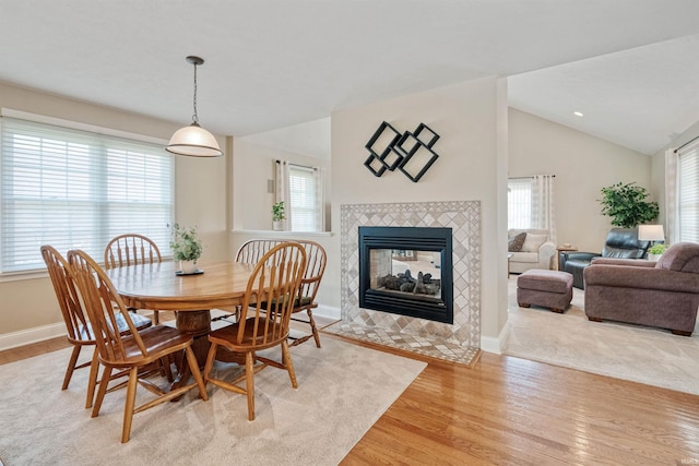2006 Capital Hill Ct, Kokomo, IN 46902 - dining room featuring light wood-style floors, a tiled fireplace, baseboards, and vaulted ceiling