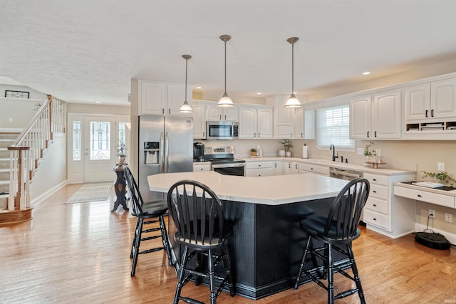 2006 Capital Hill Ct, Kokomo, IN 46902 - kitchen featuring stainless steel appliances, a kitchen bar, plenty of natural light, recessed lighting, and a center island