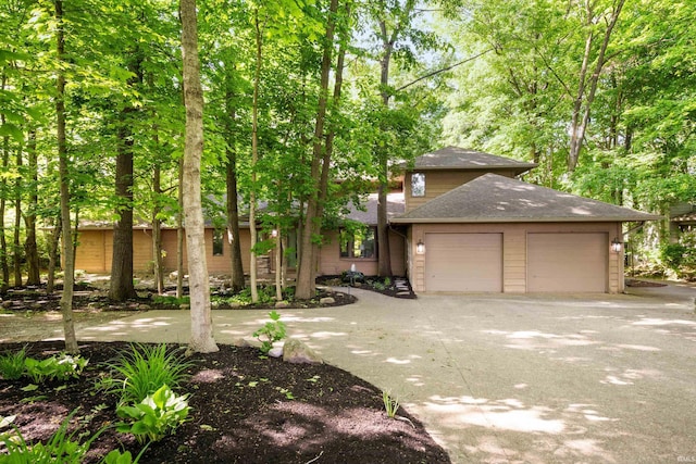 7301 W River Rd, Yorktown, IN 47396 - view of front facade with a garage, driveway, and roof with shingles