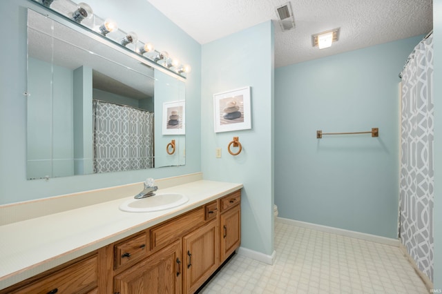7301 W River Rd, Yorktown, IN 47396 - full bath with vanity, tile patterned floors, toilet, baseboards, and a textured ceiling