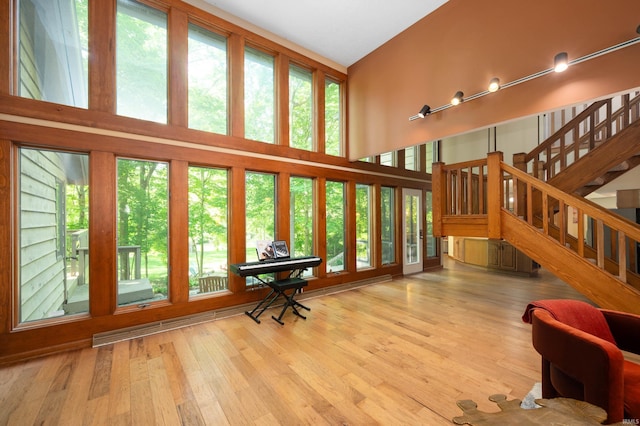 7301 W River Rd, Yorktown, IN 47396 - living area featuring a high ceiling, wood finished floors, and stairs