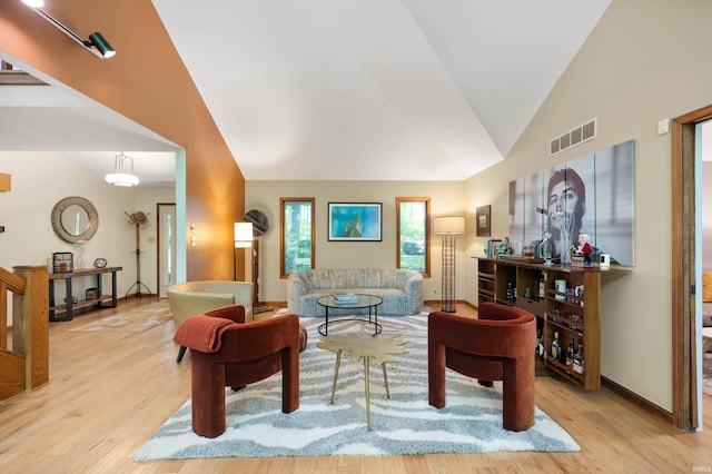 7301 W River Rd, Yorktown, IN 47396 - living area featuring wood finished floors, baseboards, and high vaulted ceiling
