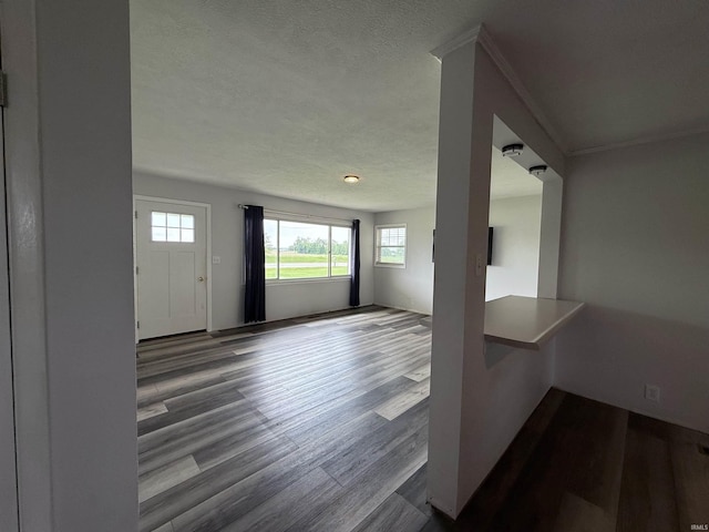 7540 S US-27 Hwy, Portland, IN 47371 - unfurnished living room featuring wood finished floors, healthy amount of natural light, and a textured ceiling