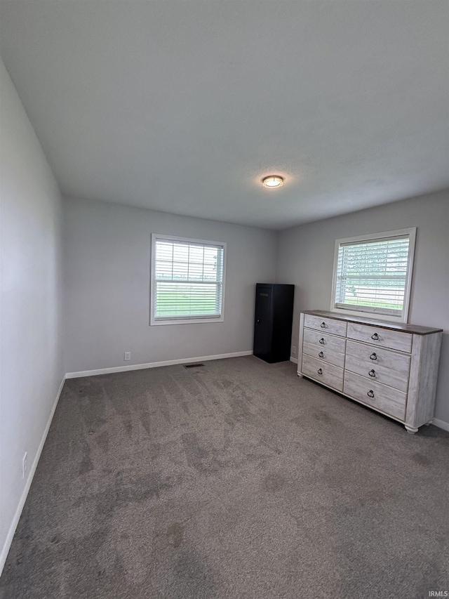 7540 S US-27 Hwy, Portland, IN 47371 - unfurnished bedroom featuring multiple windows, carpet, and baseboards