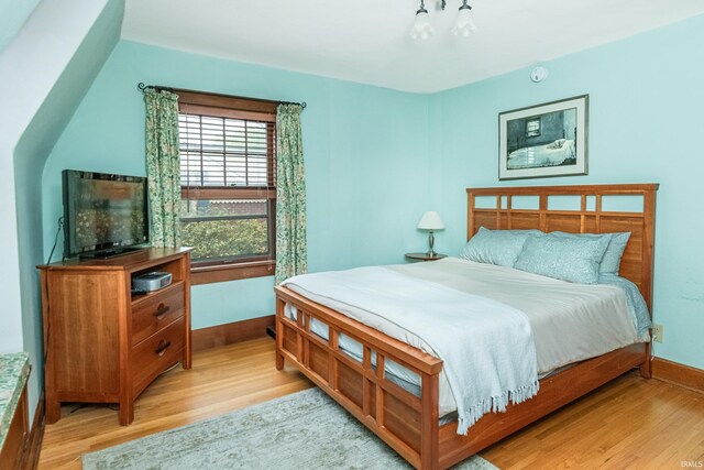 822 S Stull Ave, Bloomington, IN 47401 - bedroom with light wood-style flooring, baseboards, and a chandelier