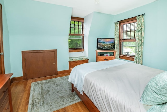 822 S Stull Ave, Bloomington, IN 47401 - bedroom featuring multiple windows, wood finished floors, and baseboards