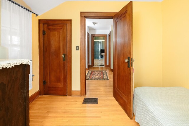 822 S Stull Ave, Bloomington, IN 47401 - bedroom with light wood-style flooring, baseboards, and lofted ceiling