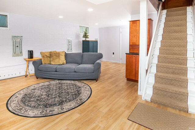 822 S Stull Ave, Bloomington, IN 47401 - living area featuring stairway, light wood-style flooring, recessed lighting, concrete block wall, and electric panel