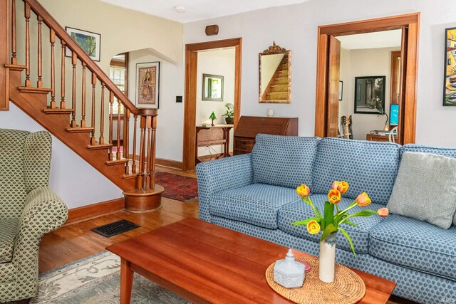 822 S Stull Ave, Bloomington, IN 47401 - living area featuring wood finished floors, stairs, arched walkways, and baseboards