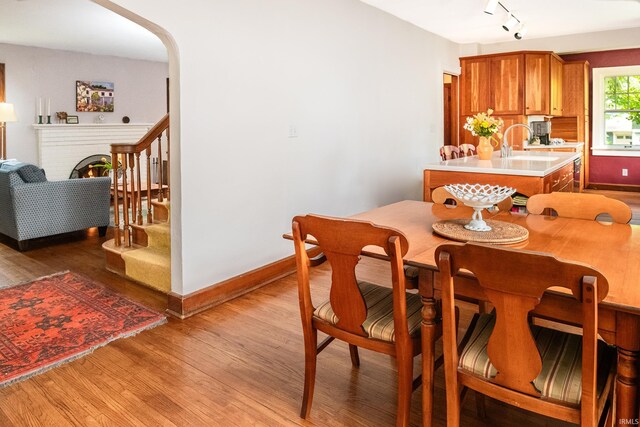 822 S Stull Ave, Bloomington, IN 47401 - dining area with light wood-style flooring, baseboards, rail lighting, and stairs