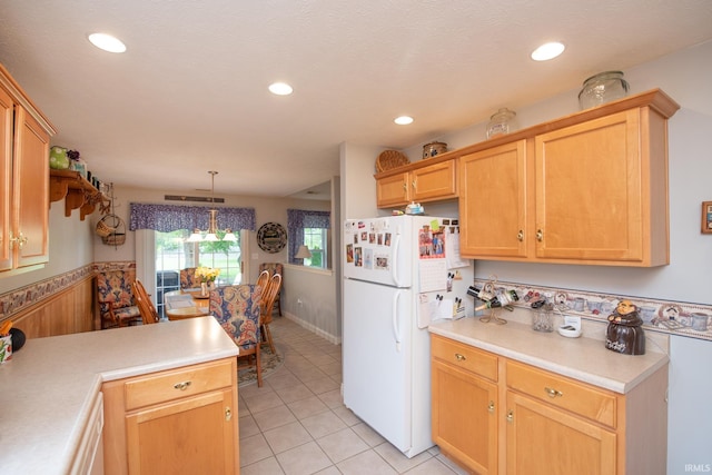 1876 Halyard Ct, West Lafayette, IN 47906 - kitchen with freestanding refrigerator, light countertops, light tile patterned flooring, pendant lighting, and recessed lighting
