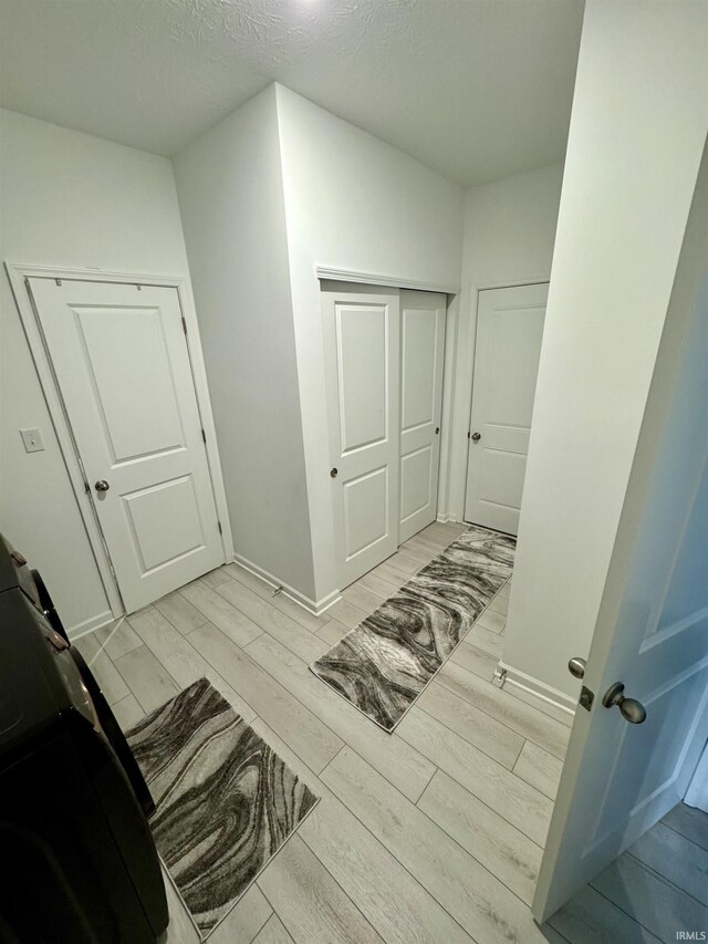 2135 Upland Ridge Way, Kokomo, IN 46902 - bathroom featuring wood tiled floors, a textured ceiling, and baseboards
