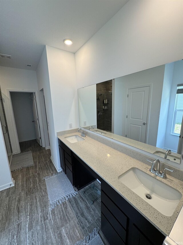 2135 Upland Ridge Way, Kokomo, IN 46902 - full bath with a shower stall, double vanity, wood finished floors, and baseboards