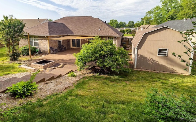 105 Temple Dr, Newburgh, IN 47630 - rear view of property with a patio, an outbuilding, a fire pit, and a shingled roof