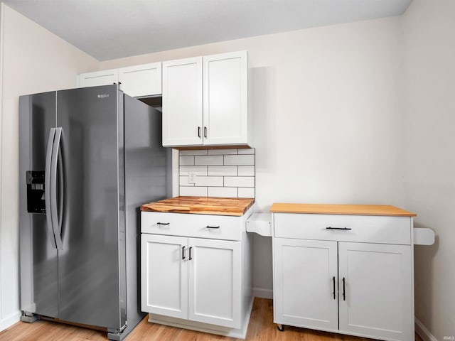 2834 Inwood Dr, Fort Wayne, IN 46815 - kitchen with stainless steel fridge with ice dispenser, light wood-style flooring, tasteful backsplash, white cabinets, and butcher block countertops