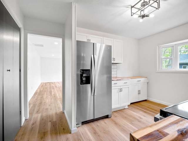 2834 Inwood Dr, Fort Wayne, IN 46815 - kitchen with stainless steel refrigerator with ice dispenser, light wood-style flooring, and white cabinetry