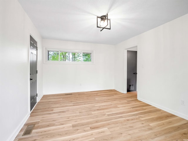 2834 Inwood Dr, Fort Wayne, IN 46815 - empty room featuring light wood-style floors, baseboards, and a chandelier