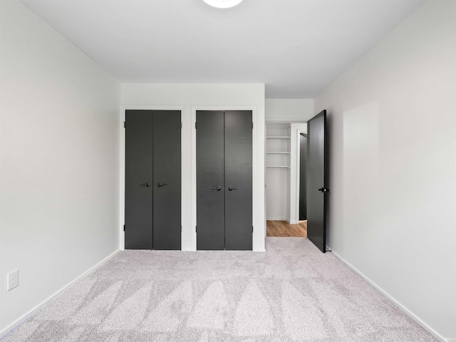 2834 Inwood Dr, Fort Wayne, IN 46815 - unfurnished bedroom featuring multiple closets, carpet floors, and baseboards