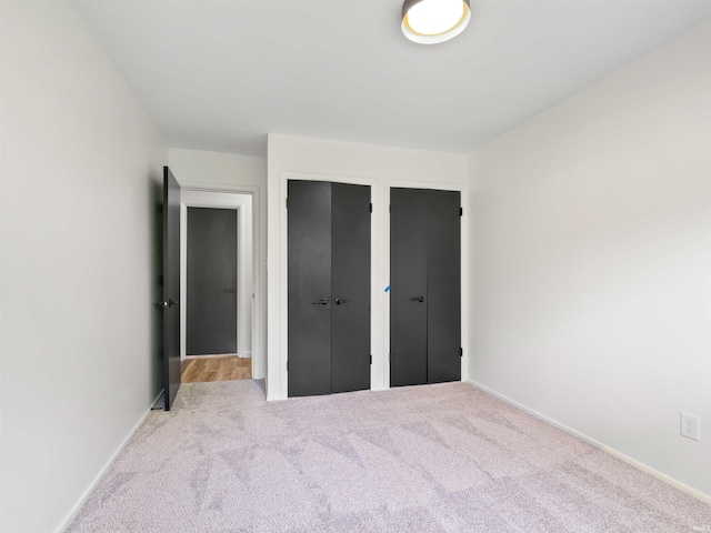 2834 Inwood Dr, Fort Wayne, IN 46815 - unfurnished bedroom with carpet, multiple closets, and baseboards