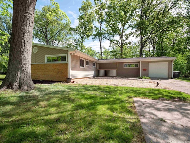 2834 Inwood Dr, Fort Wayne, IN 46815 - view of front facade with a front lawn, concrete driveway, an attached garage, and brick siding