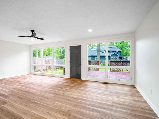 2834 Inwood Dr, Fort Wayne, IN 46815 - unfurnished room with baseboards, light wood-style floors, a ceiling fan, a textured ceiling, and recessed lighting