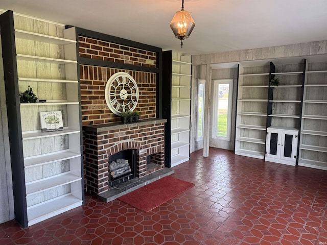 10908 Kathy Dr, Fort Wayne, IN 46835 - unfurnished living room featuring built in shelves and a fireplace