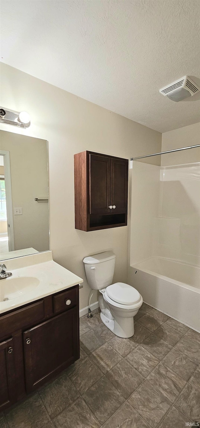 1250 W Adams Hill Cir Unit 401, Bloomington, IN 47403 - bathroom with toilet, vanity, bathtub / shower combination, baseboards, and a textured ceiling