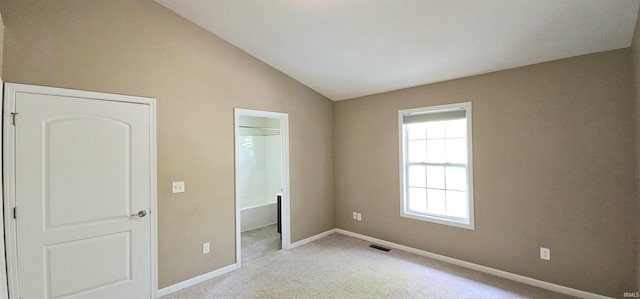 1250 W Adams Hill Cir Unit 401, Bloomington, IN 47403 - unfurnished bedroom with carpet, lofted ceiling, baseboards, and ensuite bath