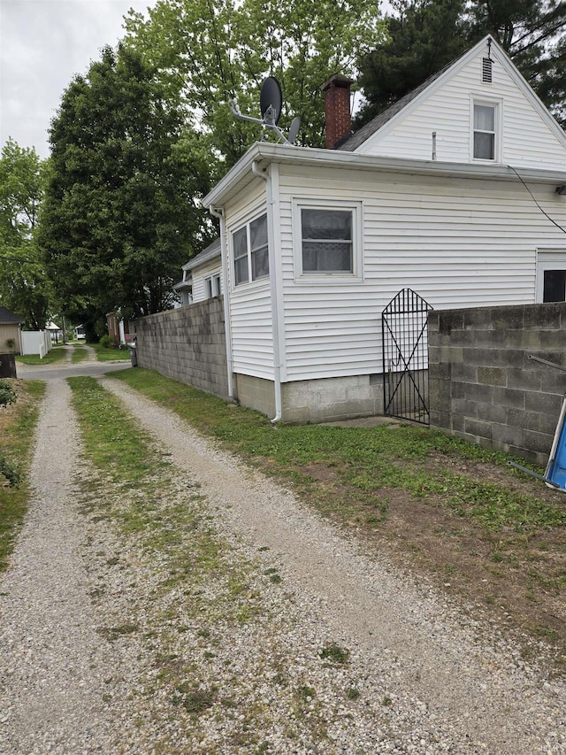 910 Ridgeway Ave, Vincennes, IN 47591 - view of home's exterior with a chimney and dirt driveway