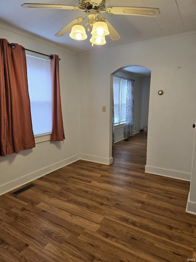 910 Ridgeway Ave, Vincennes, IN 47591 - spare room with arched walkways, crown molding, ceiling fan, baseboards, and dark wood-type flooring
