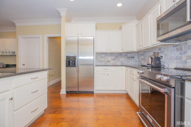 4288 Windhill Ln, Newburgh, IN 47630 - kitchen with appliances with stainless steel finishes, white cabinets, ornamental molding, tasteful backsplash, and dark stone counters