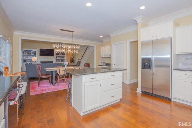 4288 Windhill Ln, Newburgh, IN 47630 - kitchen featuring stainless steel fridge, white cabinets, dark wood finished floors, ornamental molding, and a center island