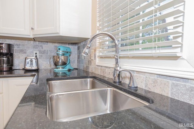 4288 Windhill Ln, Newburgh, IN 47630 - kitchen view of a sink, backsplash, white cabinetry, and dark stone countertops