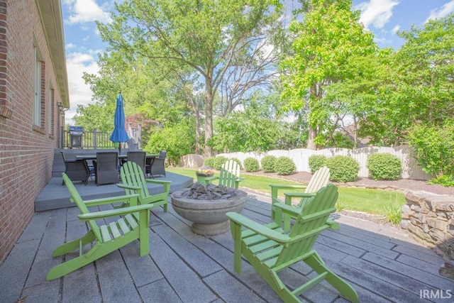 4288 Windhill Ln, Newburgh, IN 47630 - wooden deck with a fire pit, outdoor dining space, a fenced backyard, and a patio area
