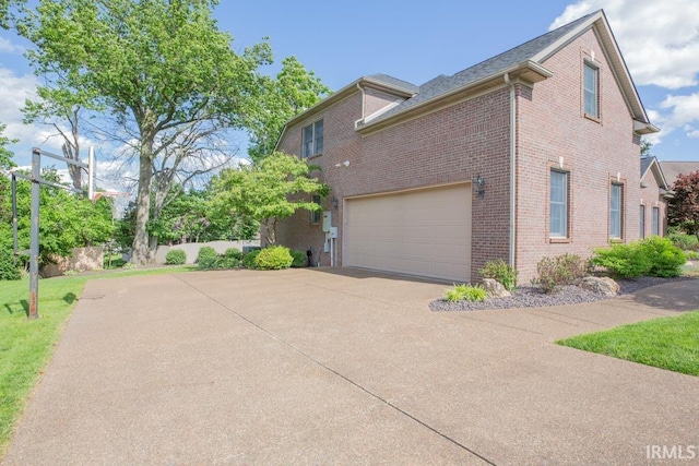 4288 Windhill Ln, Newburgh, IN 47630 - view of side of home featuring driveway, brick siding, and a garage