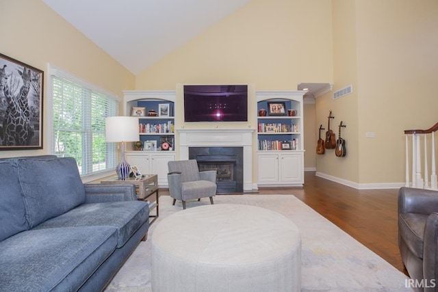 4288 Windhill Ln, Newburgh, IN 47630 - living area with high vaulted ceiling, wood finished floors, a fireplace with flush hearth, and baseboards