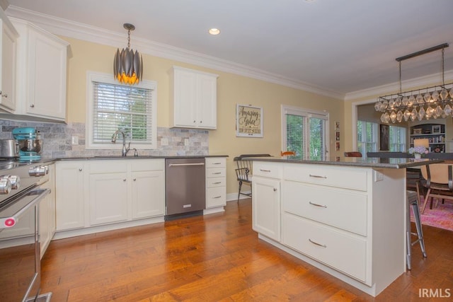 4288 Windhill Ln, Newburgh, IN 47630 - kitchen featuring stainless steel appliances, a breakfast bar area, ornamental molding, plenty of natural light, and decorative backsplash