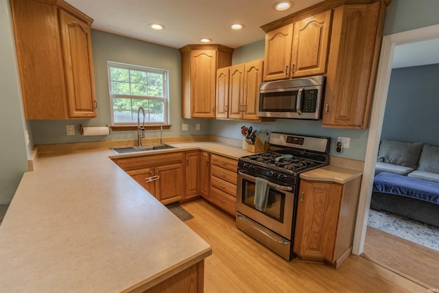 5212 E 600 S, Lafayette, IN 47909 - kitchen with appliances with stainless steel finishes, a sink, light wood finished floors, recessed lighting, and light countertops