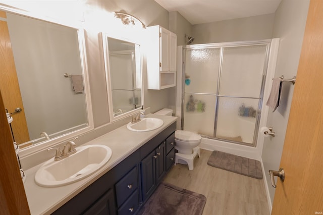 5212 E 600 S, Lafayette, IN 47909 - bathroom featuring a shower with door, toilet, wood finished floors, and double vanity