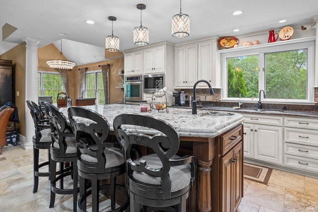 2525 Hastye Hyll, Logansport, IN 46947 - kitchen featuring a sink, light stone countertops, stone tile floors, a center island with sink, and recessed lighting