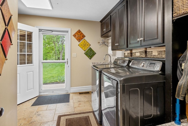 2525 Hastye Hyll, Logansport, IN 46947 - washroom with cabinet space, washing machine and dryer, stone tile floors, and baseboards